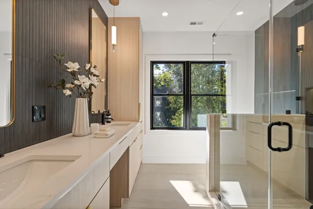 a en suite bathroom with a granite countertop sink and a bathtub