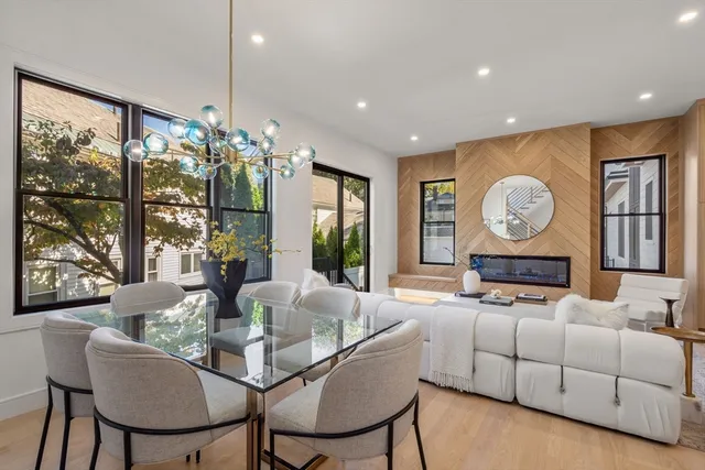 a living room with furniture a chandelier and a large window