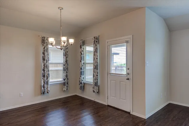 a view of a room with wooden floor staircase and a window