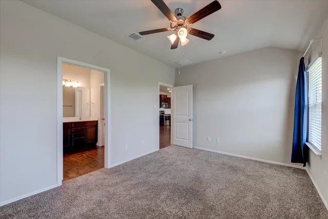 an empty room with closet and windows
