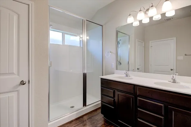 a bathroom with a double vanity sink and a mirror
