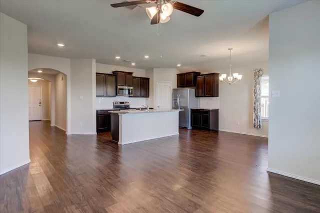 a view of kitchen with cabinets and wooden floor