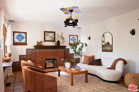 a living room with furniture and a potted plant