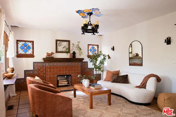 a living room with furniture and a potted plant