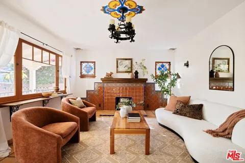 a view of a dining room with furniture and chandelier