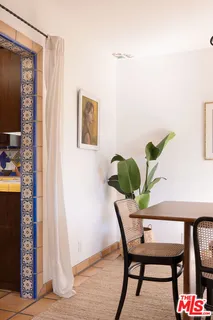 a utility room with stainless steel appliances wooden cabinets and a stove top oven