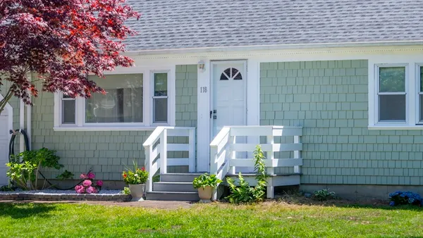 a front view of a house with a garden