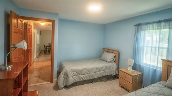 a bedroom with a bed and glass door