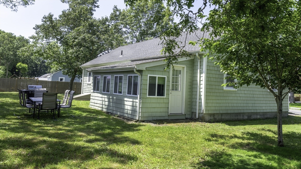 118 Walton Avenue Barnstable, MA 02601 - Photo 16 of 16 a view of a chair and table in backyard of the house