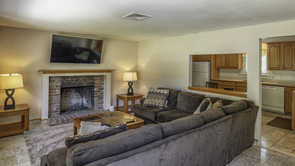 118 Walton Avenue Barnstable, MA 02601 - Photo 2 of 16 a living room with furniture and a fireplace
