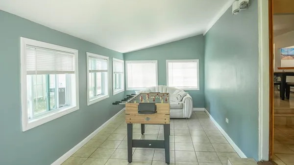 a dining room with furniture and a window