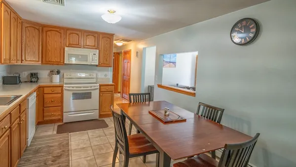a view of a kitchen with a table and chairs