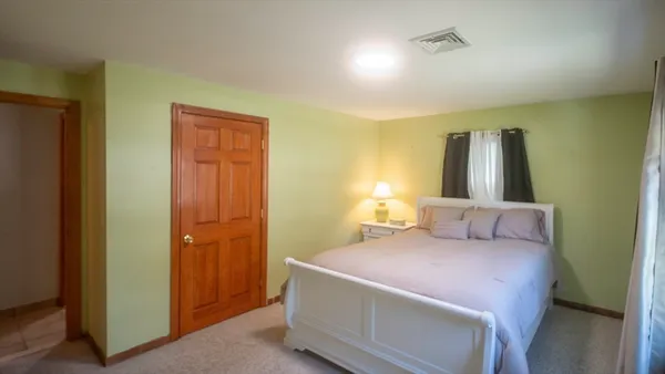 a bedroom with a bed and a table