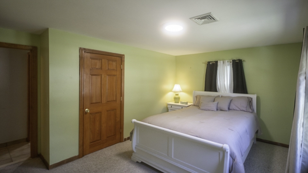 118 Walton Avenue Barnstable, MA 02601 - Photo 10 of 16 a bedroom with a bed and a table