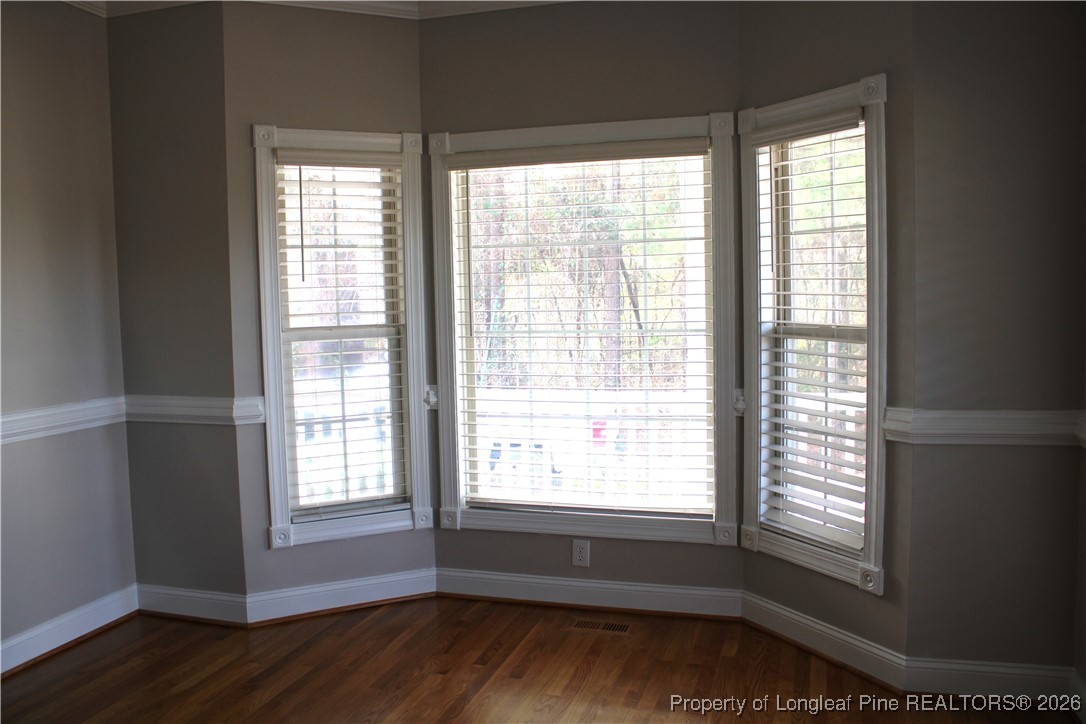 573 Porter Road Hope Mills, NC 28348 - Photo 5 of 29 a view of an empty room with wooden floor and a window