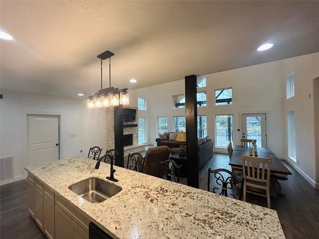 a kitchen with sink dining table and chairs