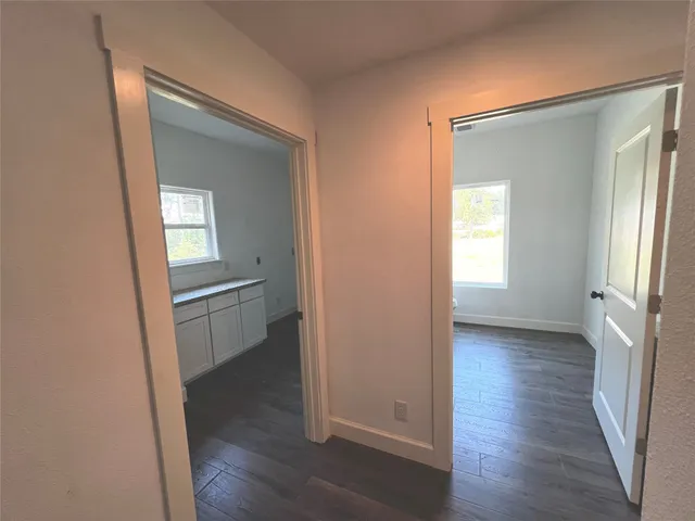 a bathroom with a granite countertop toilet and a sink