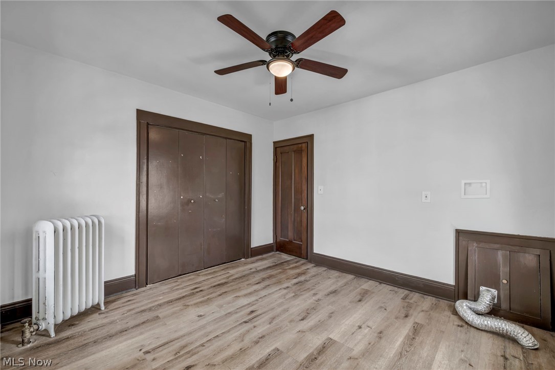 3272 Tullamore Road Cleveland, OH 44118 - Photo 31 of 47 Unfurnished bedroom with radiator, light wood-style floors, ceiling fan, and a closet