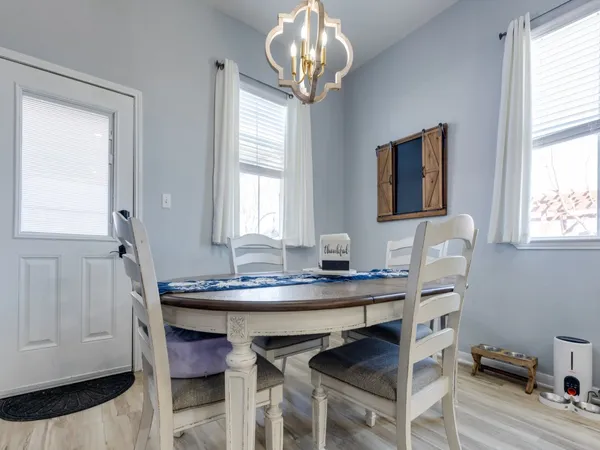 a kitchen with granite countertop white cabinets and stainless steel appliances