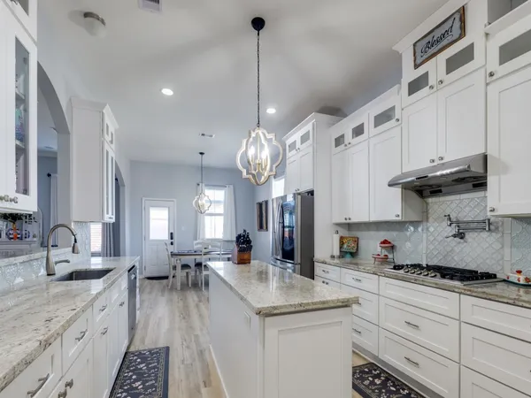 a kitchen with refrigerator and cabinets