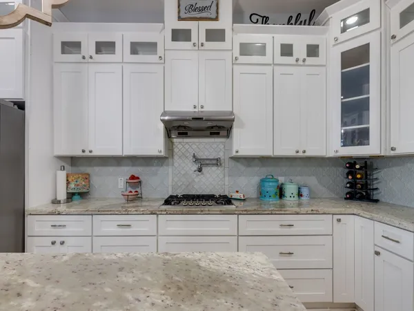 a kitchen with a refrigerator a sink and cabinets