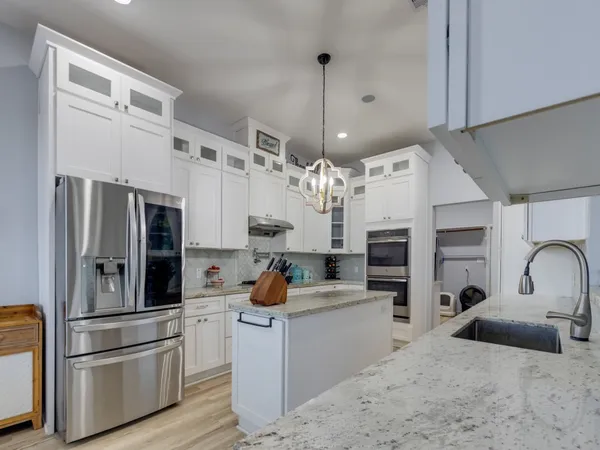 a refrigerator freezer sitting inside of a kitchen