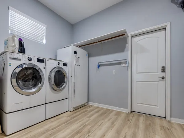a spacious bedroom with a bed and a cabinets