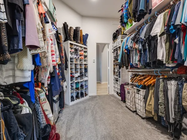 a bathroom with a granite countertop sink and a toilet