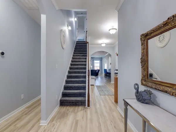 a view of entryway and hall with wooden floor