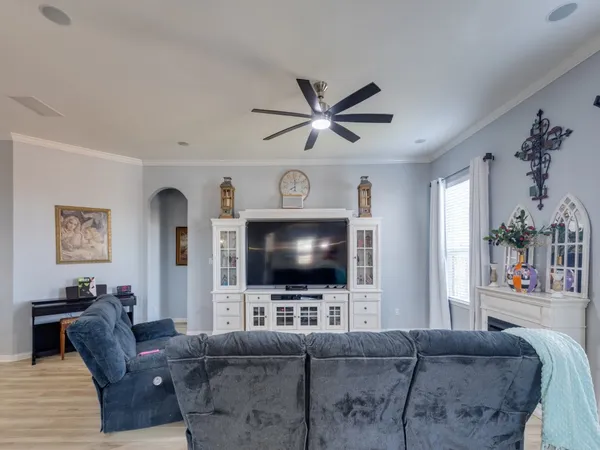 a living room with furniture and view of kitchen