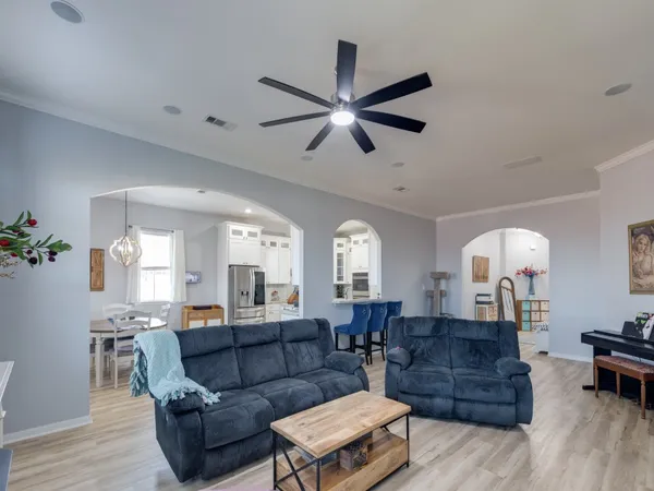 a kitchen with stainless steel appliances a refrigerator a stove microwave and a dining table with wooden floor