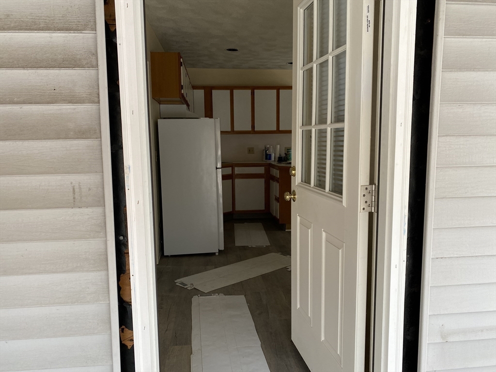 21 North Warren Street, Unit 2 Woburn, MA 01801 - Photo 2 of 12 a view of a kitchen from the hallway