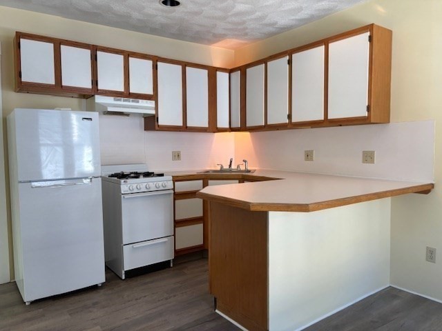 21 North Warren Street, Unit 2 Woburn, MA 01801 - Photo 3 of 12 a utility room with stainless steel appliances granite countertop a sink and a refrigerator