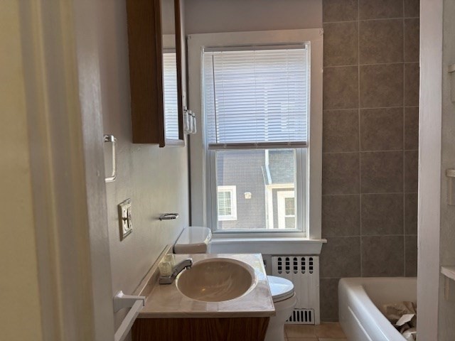 21 North Warren Street, Unit 2 Woburn, MA 01801 - Photo 5 of 12 a bathroom with a sink a toilet and tub