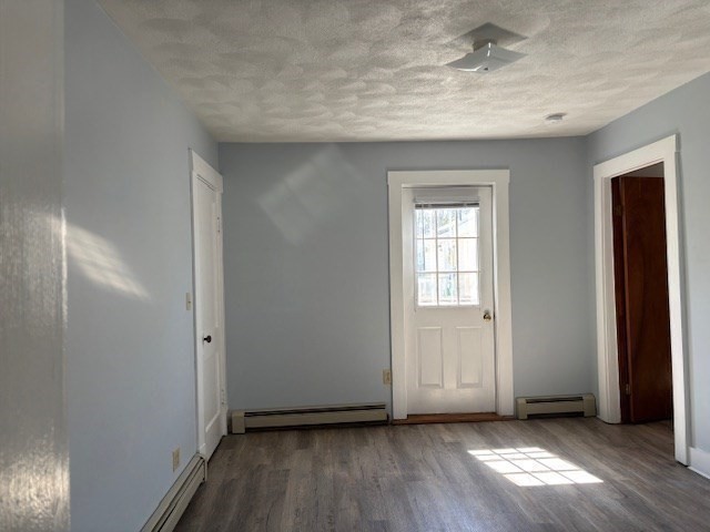 21 North Warren Street, Unit 2 Woburn, MA 01801 - Photo 7 of 12 an empty room with wooden floor and windows