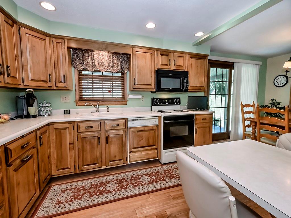 2501 Braddock Drive Lower Burrell, PA 15068 - Photo 2 of 22 a kitchen with stainless steel appliances granite countertop a stove top oven a sink dishwasher and a refrigerator with wooden cabinets