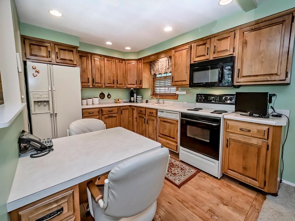 2501 Braddock Drive Lower Burrell, PA 15068 - Photo 3 of 22 a kitchen with stainless steel appliances granite countertop a stove a sink dishwasher a refrigerator white cabinets and wooden floor