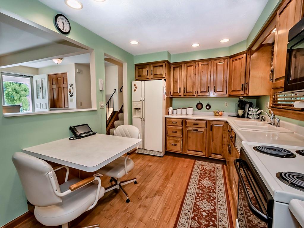 2501 Braddock Drive Lower Burrell, PA 15068 - Photo 5 of 22 a kitchen with a table chairs a stove a window and cabinetry
