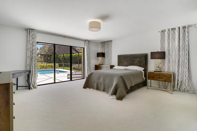 a spacious bedroom with a bed and a large window