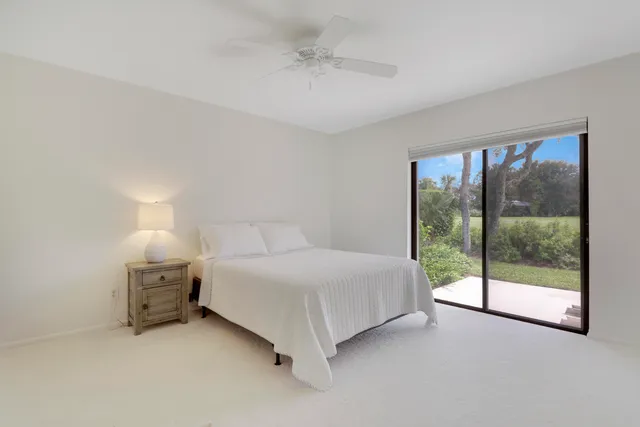 a bedroom with a bed and a night stand