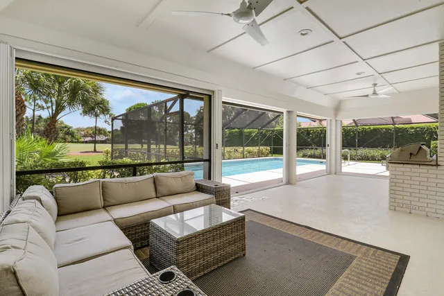 a living room with furniture and a floor to ceiling window