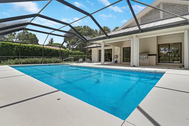 a view of a patio with a table and chairs under an umbrella