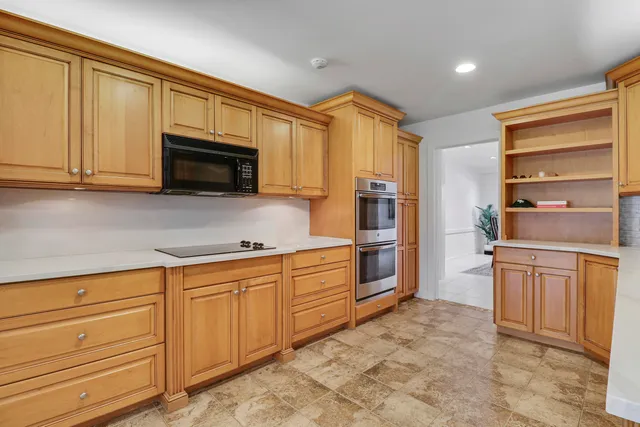 a kitchen with stainless steel appliances granite countertop a refrigerator and cabinets