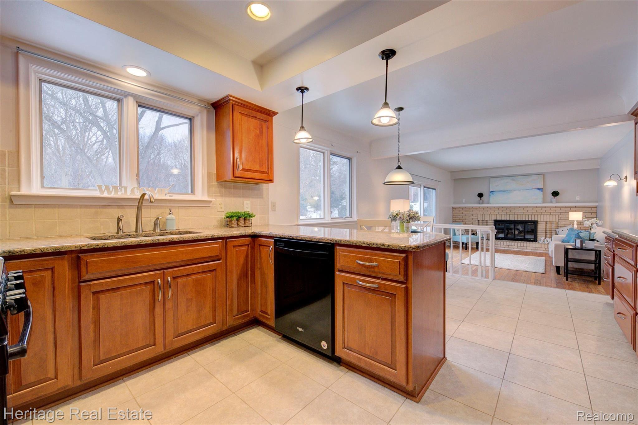 654 Old Perch Road Rochester, MI 48309 - Photo 18 of 61 This fabulous kitchen has built in pantry-cabinets, abundant cabinetry and counter top space, a desk area, and granite counter tops