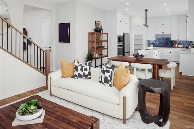 a living room with kitchen island furniture and a wooden floor
