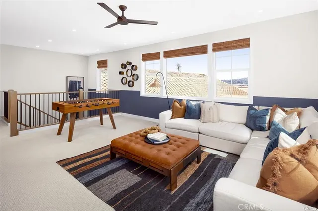 a living room with furniture a rug and a large window