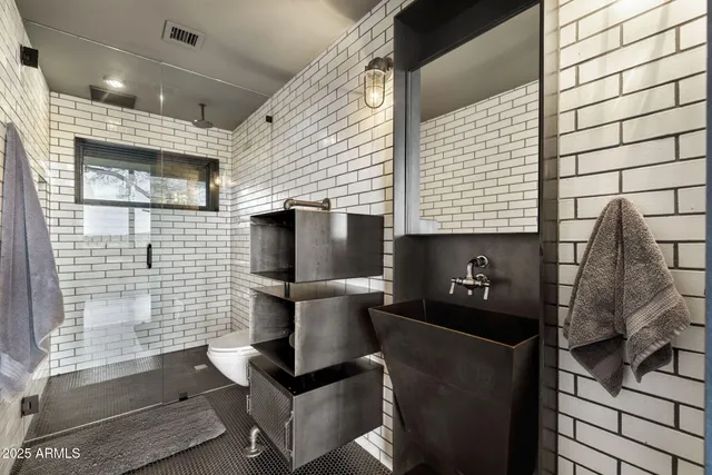 a bathroom with a toilet sink and mirror