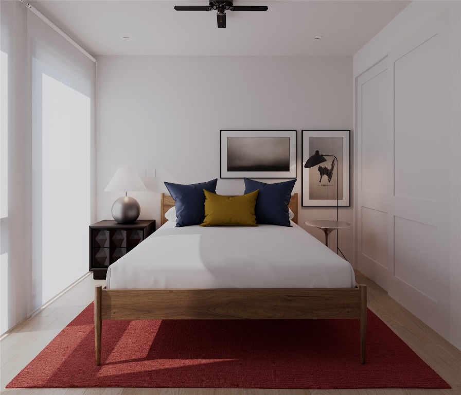 205 Medina Street, Unit 1 Austin, TX 78702 - Photo 10 of 15 Bedroom with a ceiling fan and light wood-style flooring