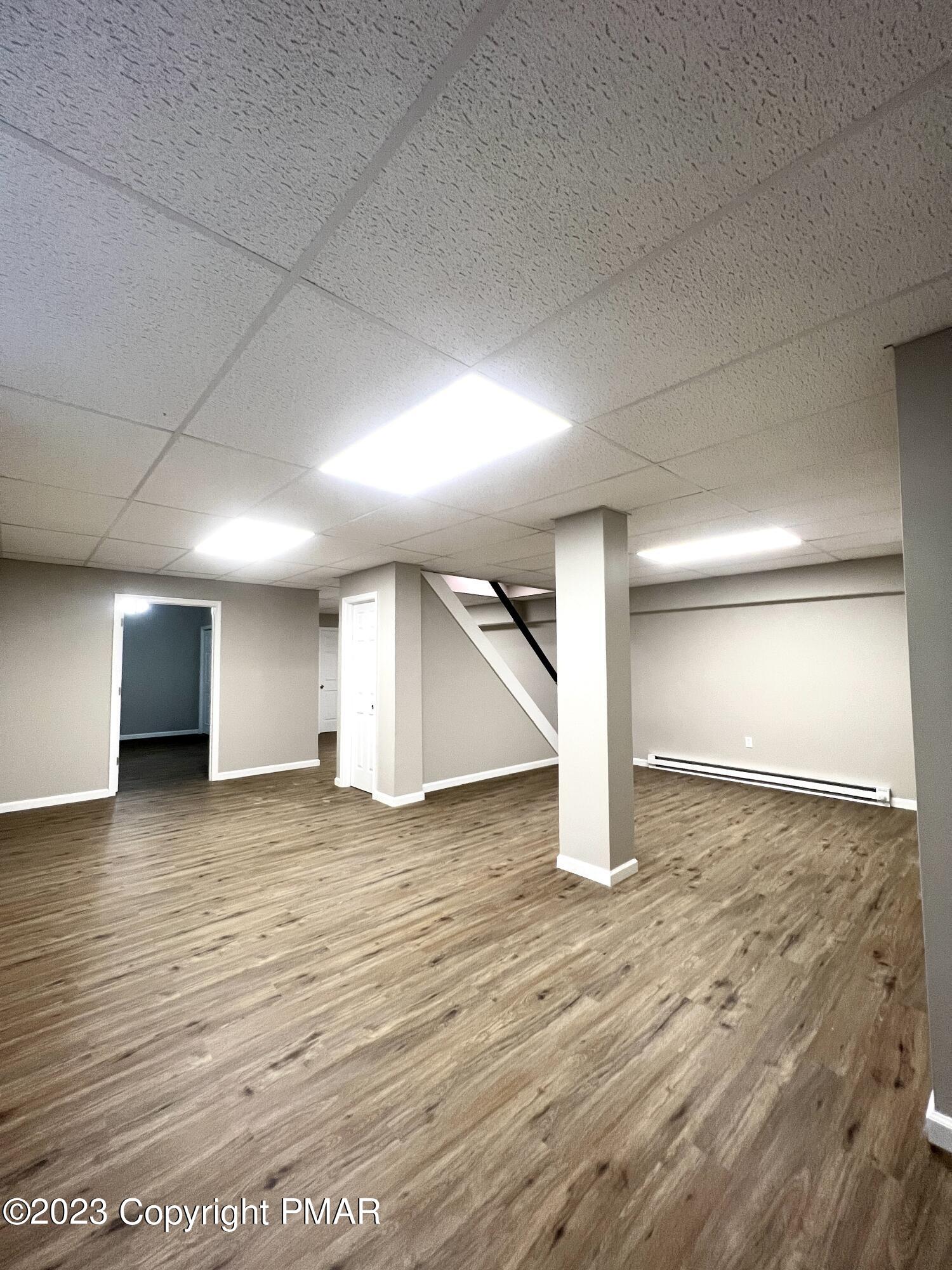 179 Gold Finch Road Bushkill, PA 18324 - Photo 11 of 15 an empty room with wooden floor and windows