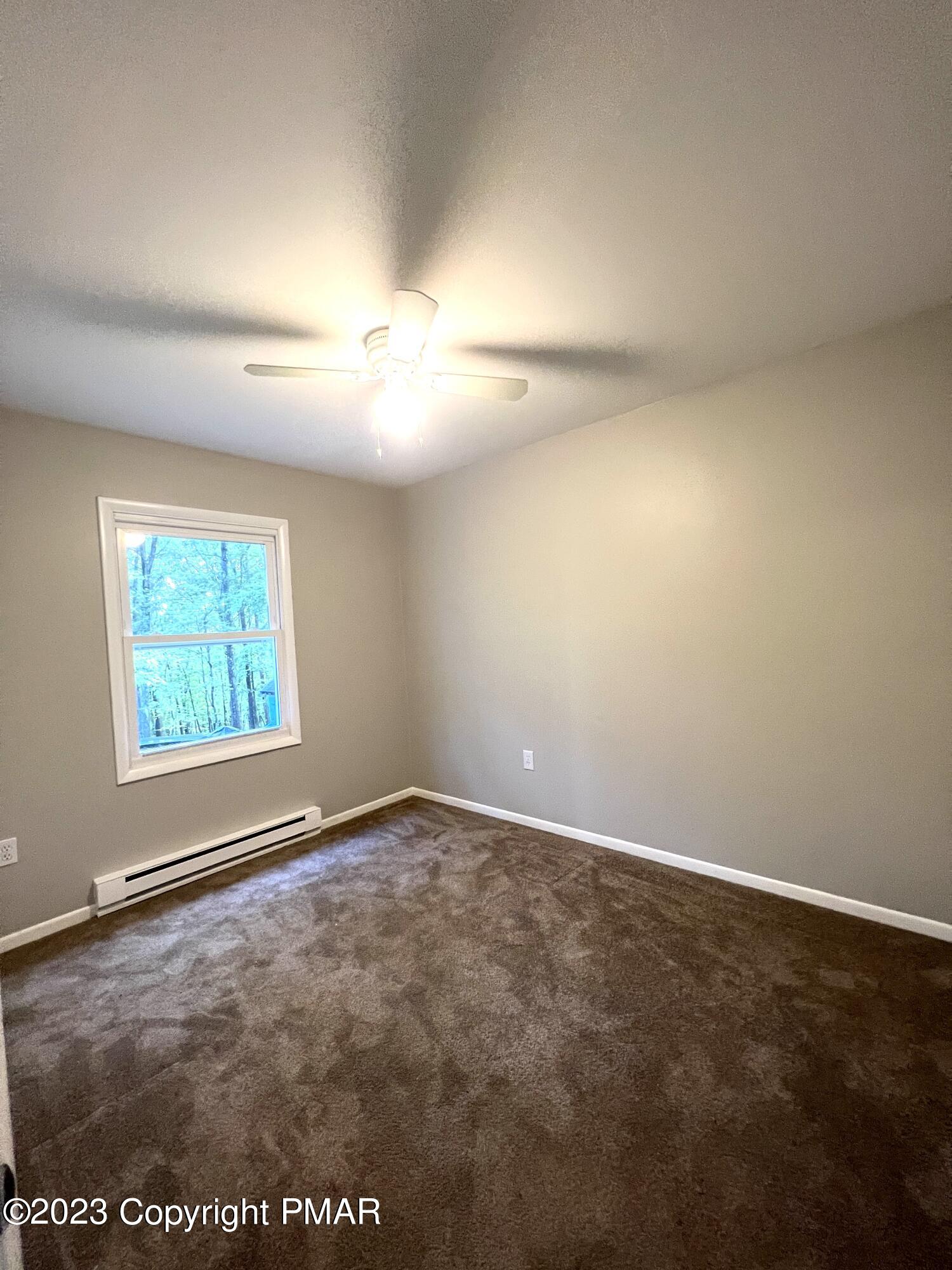 179 Gold Finch Road Bushkill, PA 18324 - Photo 7 of 15 an empty room with windows and fan